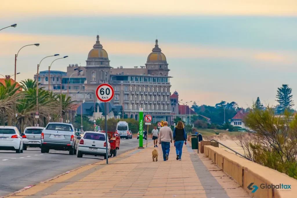 Couple walking along the Carrasco waterfront by Hotel Carrasco in Montevideo